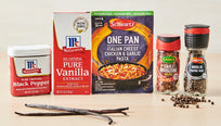 Assorted McCormick, Schwartz, Kamis, and Ducros seasoning products with vanilla beans and peppercorns.