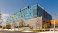 Exterior of a modern McCormick India office building with glass windows.