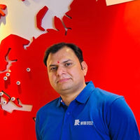Man in a blue McCormick polo standing in front of a red wall map.